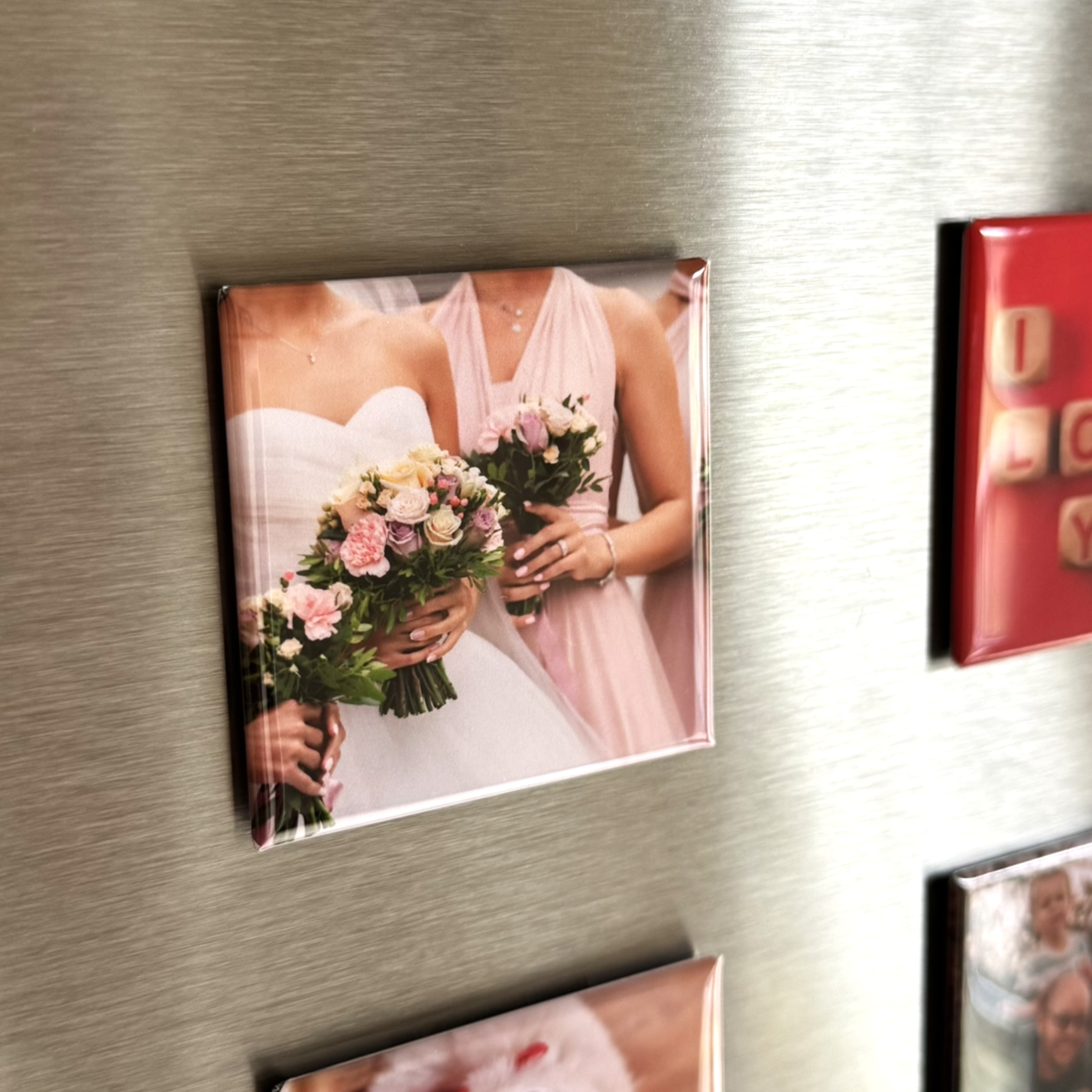 Photo magnet of a bridal party holding flowers on a refrigerator