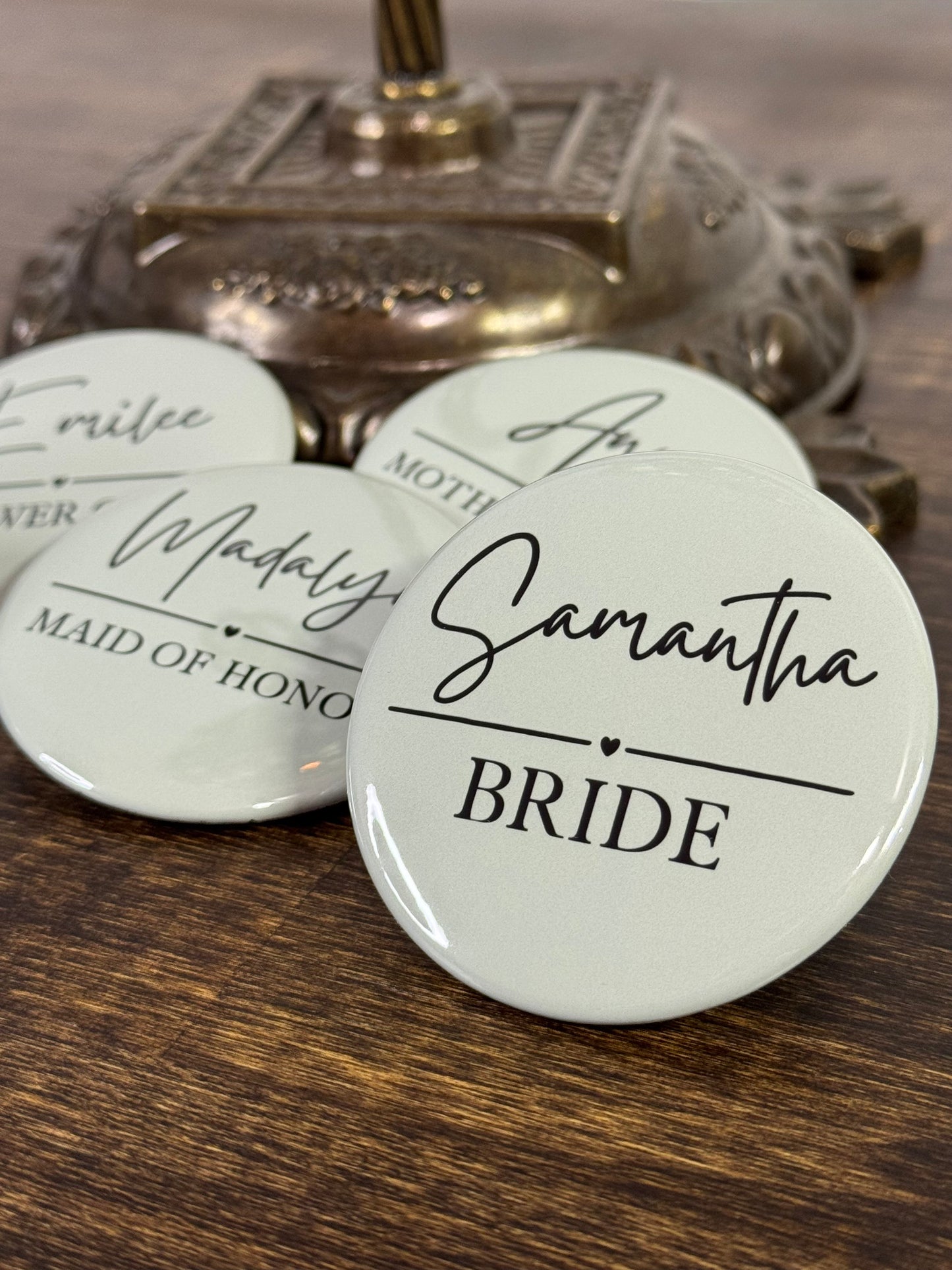 Round badges with names and bridal party roles